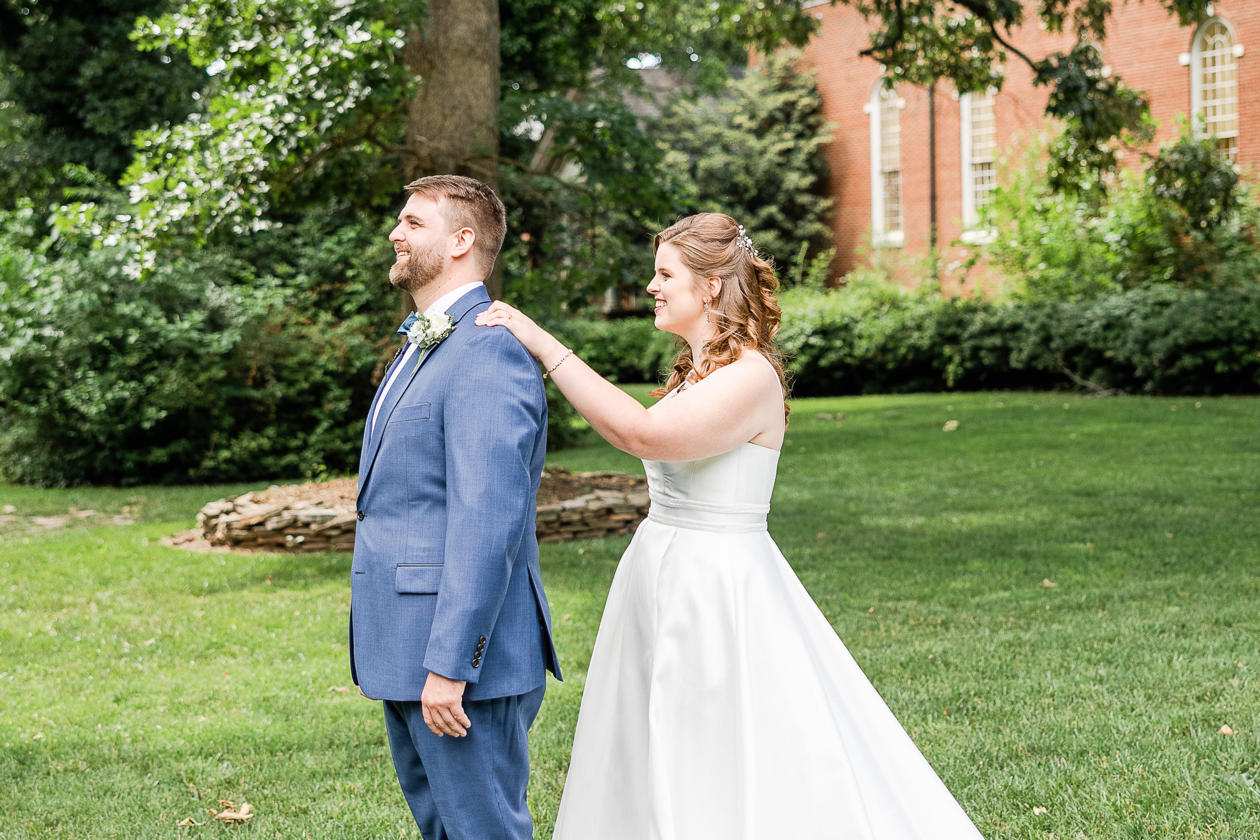 bride taps groom's shoulder for first look at wedding